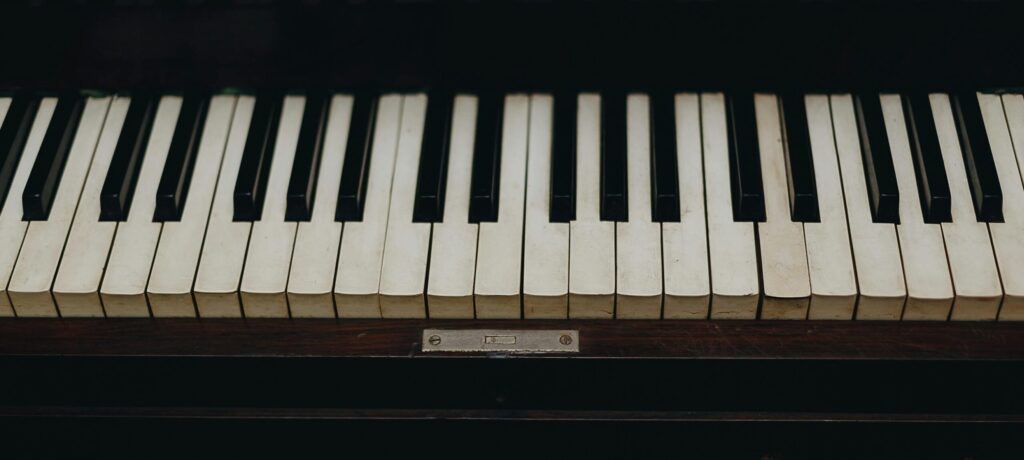A close-up view of vintage piano keys showcasing the wear and character of the instrument.